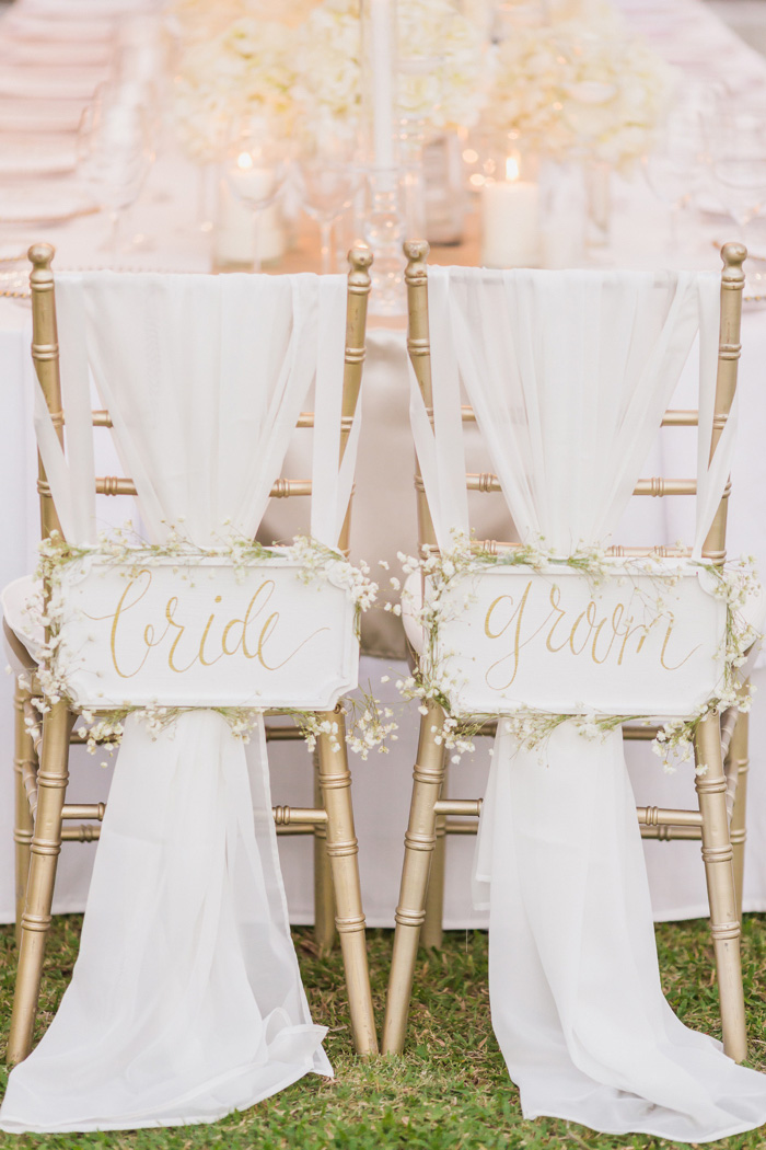 bride and groom signs on back of chairs