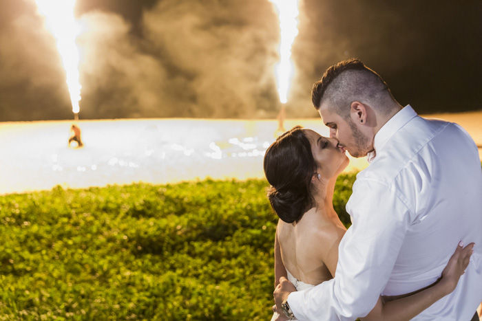 bride and groom kissing wth fireworks