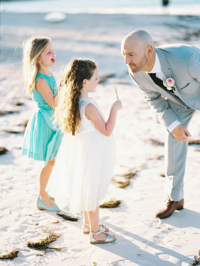 groom on the beach with step daughter