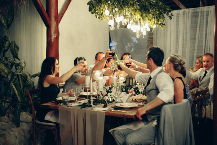 wedding guests raising their glasses