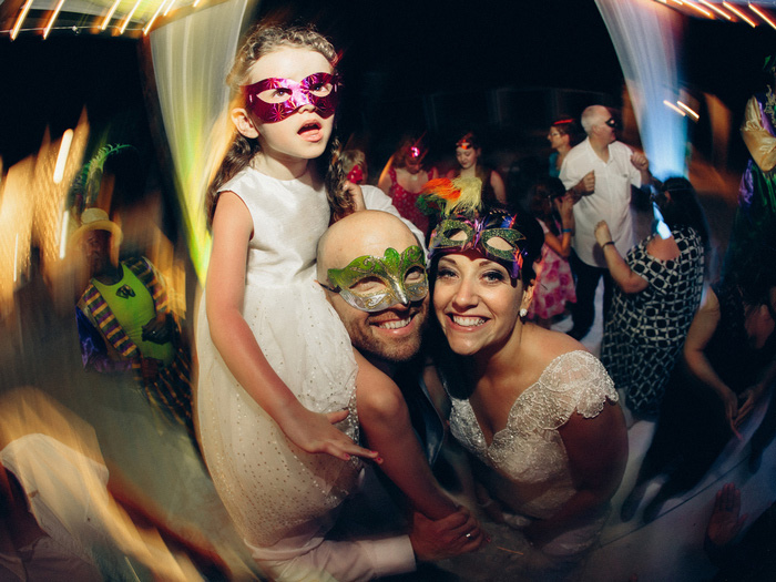 bride, groom, ad daughter at wedding reception