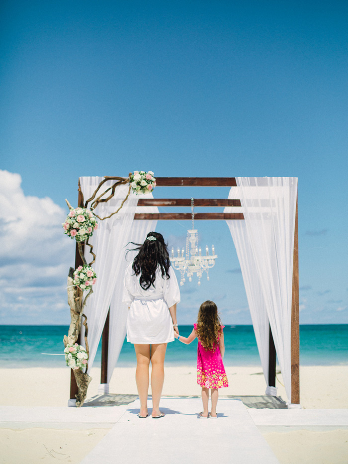 bride and daughter standing in front of altar before ceremony