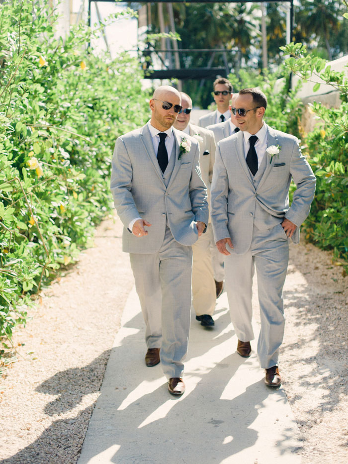 groomsmen walking to the beach