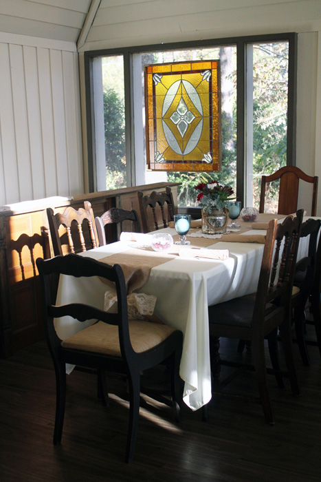 Rehearsal-Table-at-rail-towards-stained-glass